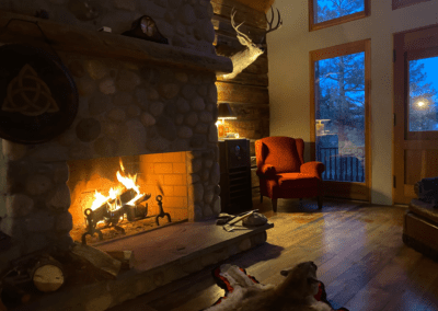 a fireplace in a log cabin